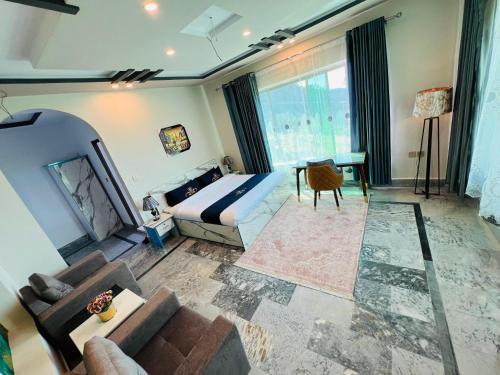 a bedroom with a bed and a couch and a table at Hilton Resort Malamjabba by Khan Familia Travels in Malam Jabba