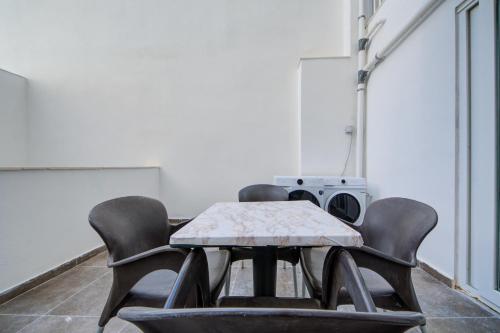 a room with chairs and a table with a speaker at The St Pauls Bay Escape Suites by 360 Estates in St Paul's Bay