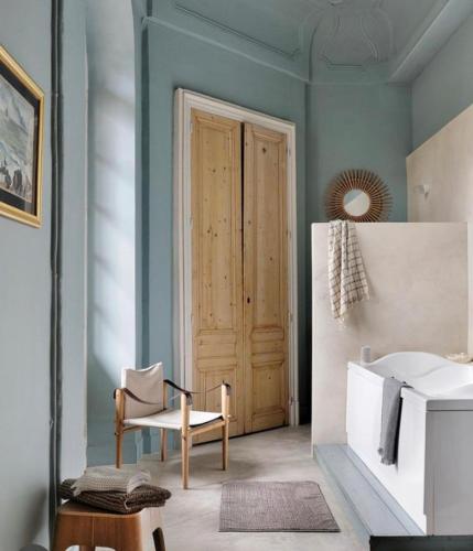 a bathroom with a door and a chair and a sink at Une Nuit Au Château in Lyon