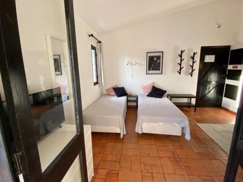 a room with two beds and a couch at Studio Pedras del Rei - Casa Verde in Tavira