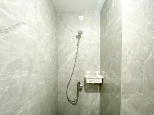 a bathroom with a shower with a shower head at Comfy and Simply Look Studio Room Sayana Bekasi Apartment By Travelio in Bekasi