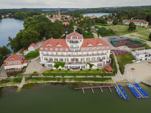 an aerial view of a large white building with a red roof at Hotel Woiński Spa in Lubniewice