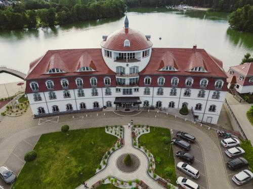 an aerial view of a large white building with a red roof at Hotel Woiński Spa in Lubniewice