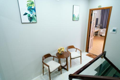 a dining room with a table and two chairs at Khách sạn Minh Long in Tuy Hoa
