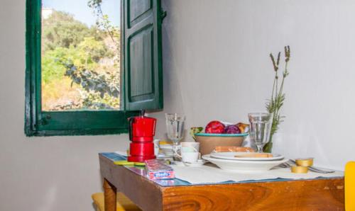a table with a plate of food on it at Casa Betta e Elisa in Valderice