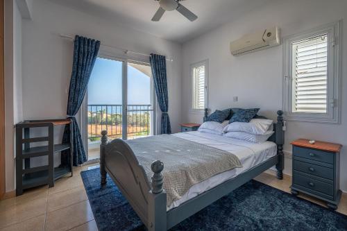 a bedroom with a bed and a window with a view at Villa Nikita in Argaka