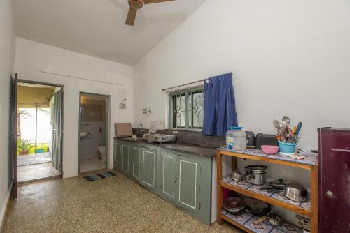 a kitchen with green cabinets and a counter top at Seaview White beach Villa on Talpona in Magdāl