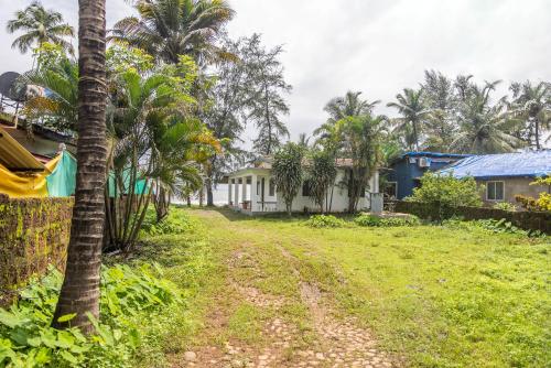 a dirt road through a village with palm trees at Seaview White beach Villa on Talpona in Magdāl