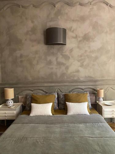 a bedroom with a large bed with two night stands at Une Nuit Au Château in Lyon