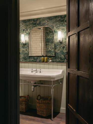 a bathroom with a sink and a mirror at Boys Hall in Willesborough