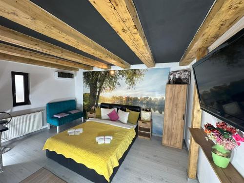 a bedroom with a bed and a large screen at Smart Studio free parking in Craiova