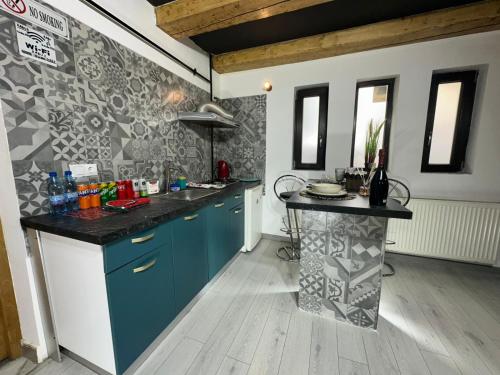 a kitchen with blue cabinets and a counter top at Smart Studio free parking in Craiova