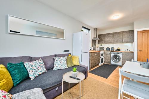 ein Wohnzimmer mit Couch und Küche in der Unterkunft Princess Green 5 - Portrush by the Sea in Portrush