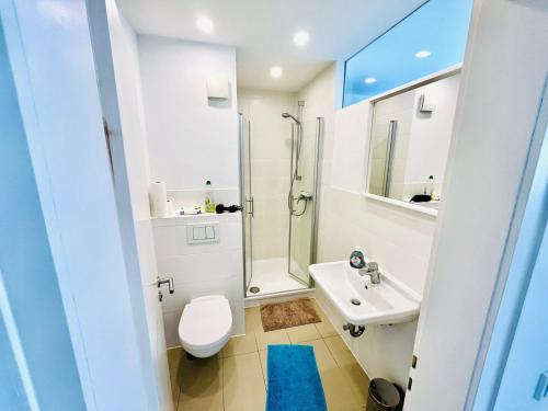 a white bathroom with a toilet and a sink at Apartment in Bergisch Gladbach in Bergisch Gladbach