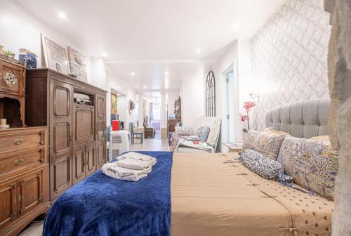 a bedroom with a bed and a dresser in a room at Fernando Lemos Estúdio Lisboa in Lisbon