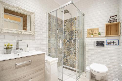a bathroom with a shower and a toilet and a sink at Fernando Lemos Estúdio Lisboa in Lisbon