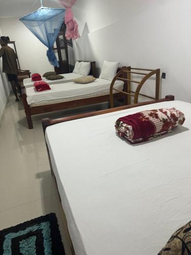 a room with two beds at Viyanga Homestay in Ella