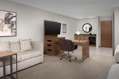 a living room with a couch and a desk at Hampton Inn & Suites Paso Robles in Paso Robles