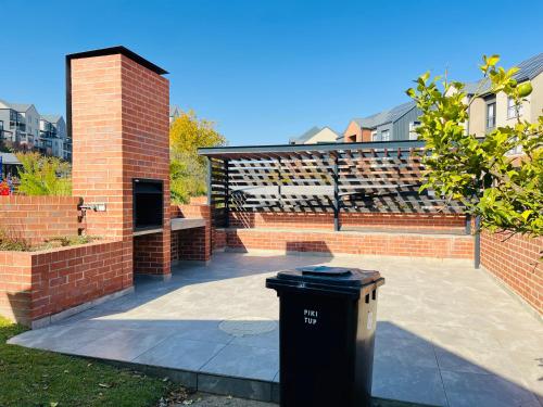 a trash can sitting in the middle of a patio at 12 Elizabeth Place - Beautiful self catering 2 bedroom unit next to Kyalami Racetrack with free WiFi - swimming pool gym and restaurant - Perfect for a small family in Midrand Waterfall in Midrand