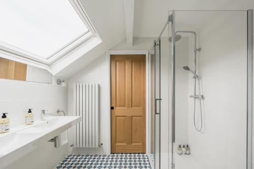 a bathroom with a shower and a glass door at Brantwood - 4 bed home Ambleside in Ambleside