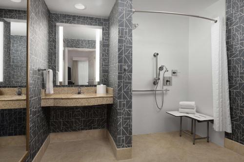 a bathroom with two sinks and a shower at Homewood Suites by Hilton Raleigh-Durham Airport at RTP in Durham