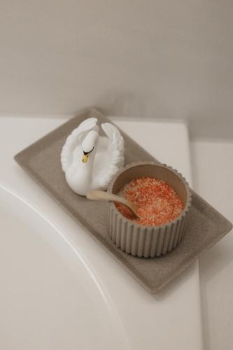 a plate with a bird and a bowl of sprinkles at Mandarin Oriental Palace, Luzern in Lucerne