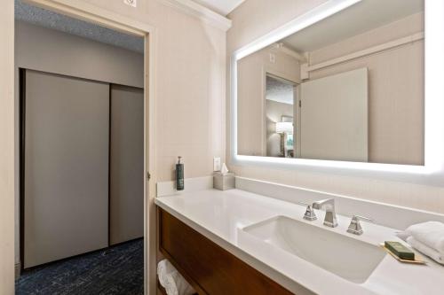 a bathroom with a sink and a mirror at DoubleTree by Hilton Spokane City Center in Spokane