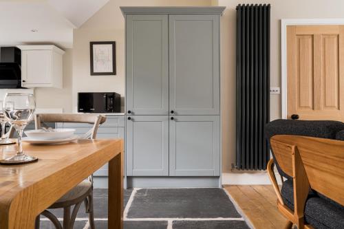a kitchen with a dining table and a cabinet at Brantwood - 4 bed home Ambleside in Ambleside
