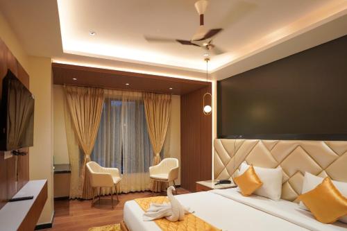 a hotel room with a large bed and a window at Hotel Beyond Blu,Port Blair in Port Blair