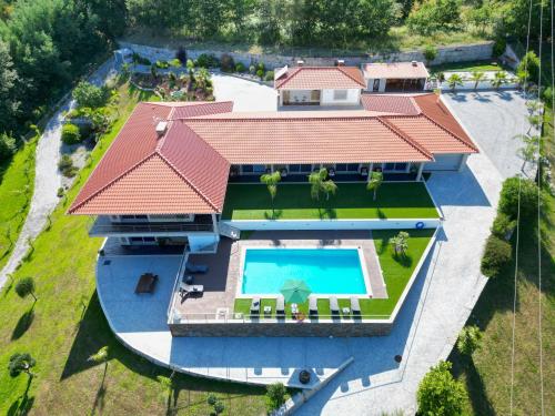 an aerial view of a house with a swimming pool at Ermal Village in Vieira do Minho