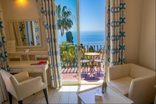 a living room with a view of the ocean at Hotel Ariston and Palazzo Santa Caterina in Taormina