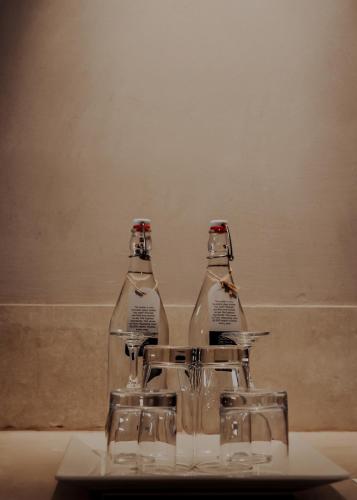 two glass bottles sitting on top of a table at The Valle by Kondody Hotels in Munnar