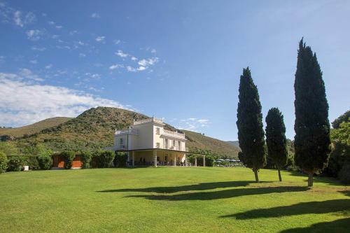 a large white house with trees in a field at Primavilla Relais in Gaeta