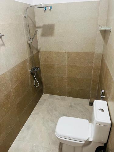 a bathroom with a toilet and a shower at Viyanga Homestay in Ella