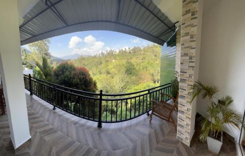 a room with a balcony with a view at Viyanga Homestay in Ella