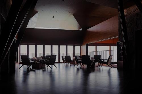 a large room with chairs and a table in it at The Valle by Kondody Hotels in Munnar
