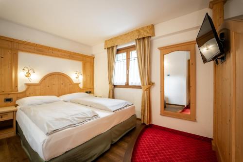 Ένα ή περισσότερα κρεβάτια σε δωμάτιο στο Chalet Campiglio Imperiale