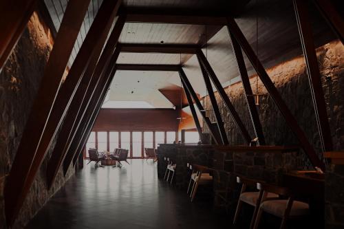 a room with chairs and tables in a building at The Valle by Kondody Hotels in Munnar