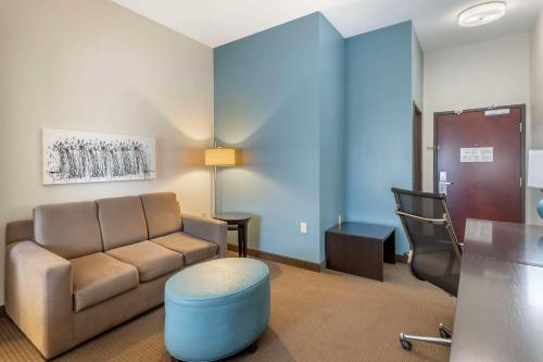a living room with a couch and a chair at Sleep Inn & Suites Norman near University in Norman