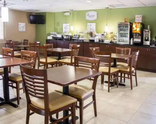 a dining room with tables and chairs in a restaurant at Sleep Inn & Suites Near Columbus - State University Area in Columbus