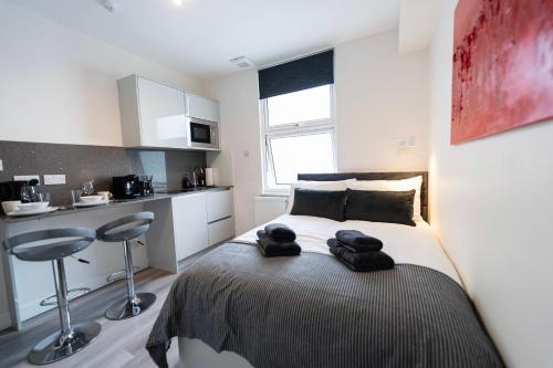 a bedroom with a bed with towels on it at Boutique Studios by Luxestays Fulham Broadway in London