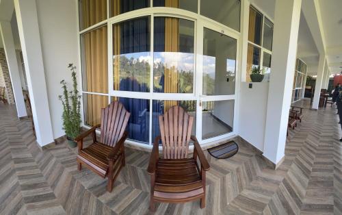 two chairs sitting in front of a window on a porch at Viyanga Homestay in Ella
