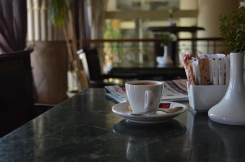 a cup of coffee sitting on top of a table at Swiss Inn Nile Hotel in Cairo