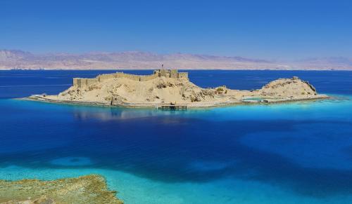 an island in the middle of a body of water at Steigenberger Hotel & Nelson Village, Taba in Taba