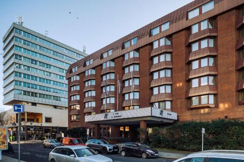 a large building with cars parked in front of it at pentahotel Reading in Reading