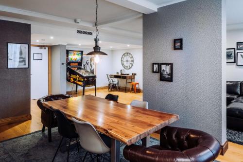 a dining room with a wooden table and chairs at pentahotel Reading in Reading