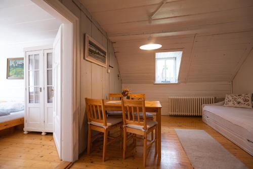 a dining room with a wooden table and chairs at Penzion Statek u Rajtrů in Bedřichov