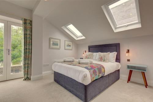 a bedroom with a large bed and a window at Beresford House in Wells next the Sea