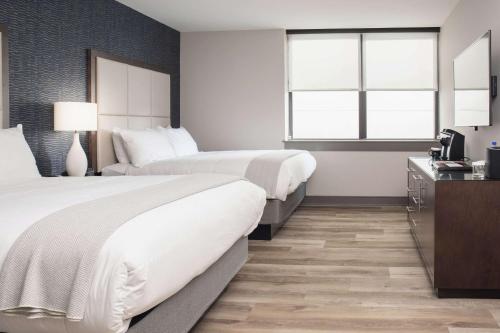 a hotel room with two beds and a television at Haywood Park Hotel, an Ascend Collection Hotel in Asheville