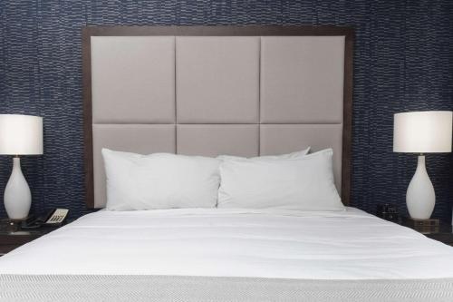 a bedroom with a white bed with two lamps at Haywood Park Hotel, an Ascend Collection Hotel in Asheville